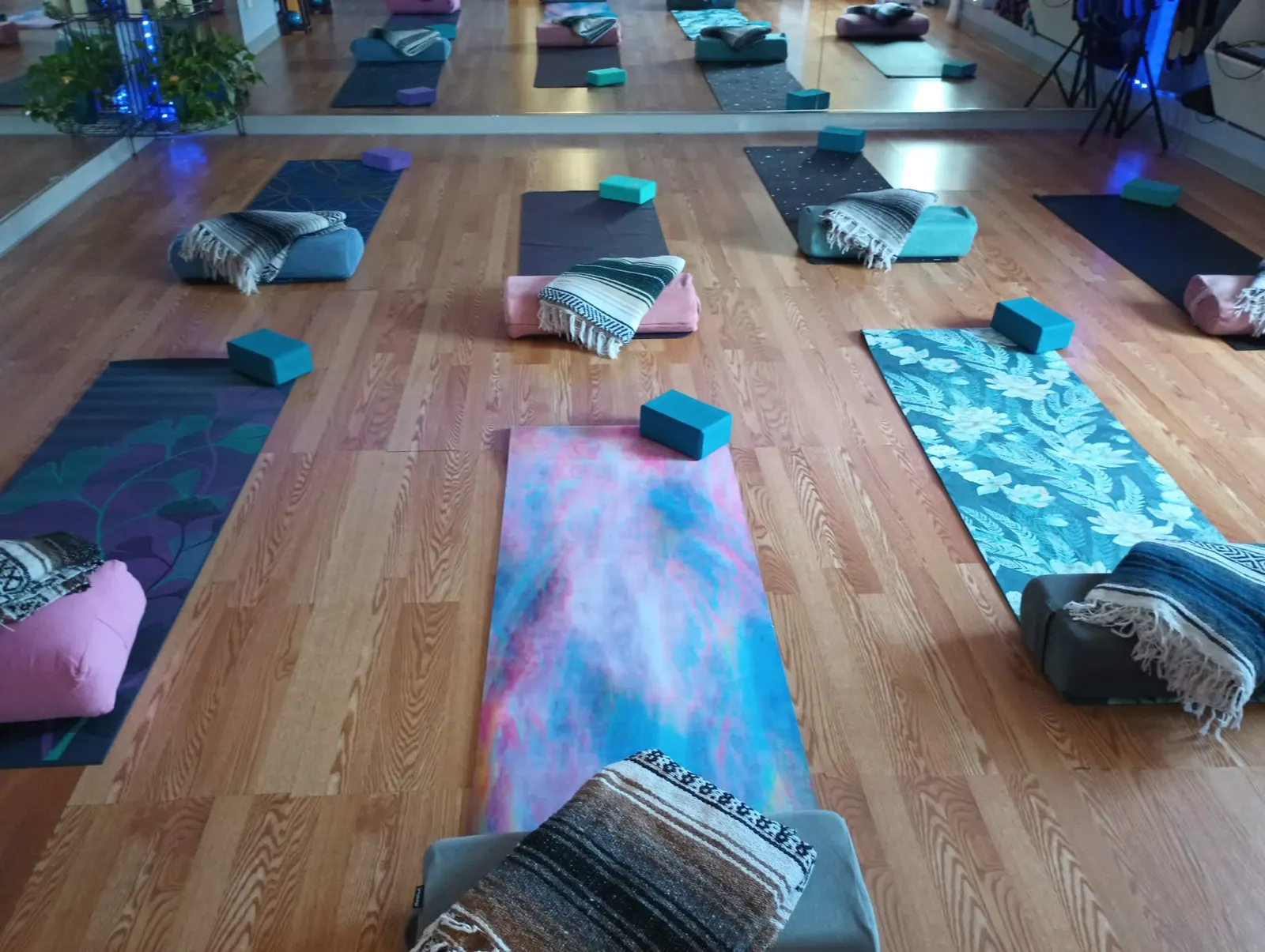Yoga mats, blocks and blankets set out in the Gravity Yoga Center studio